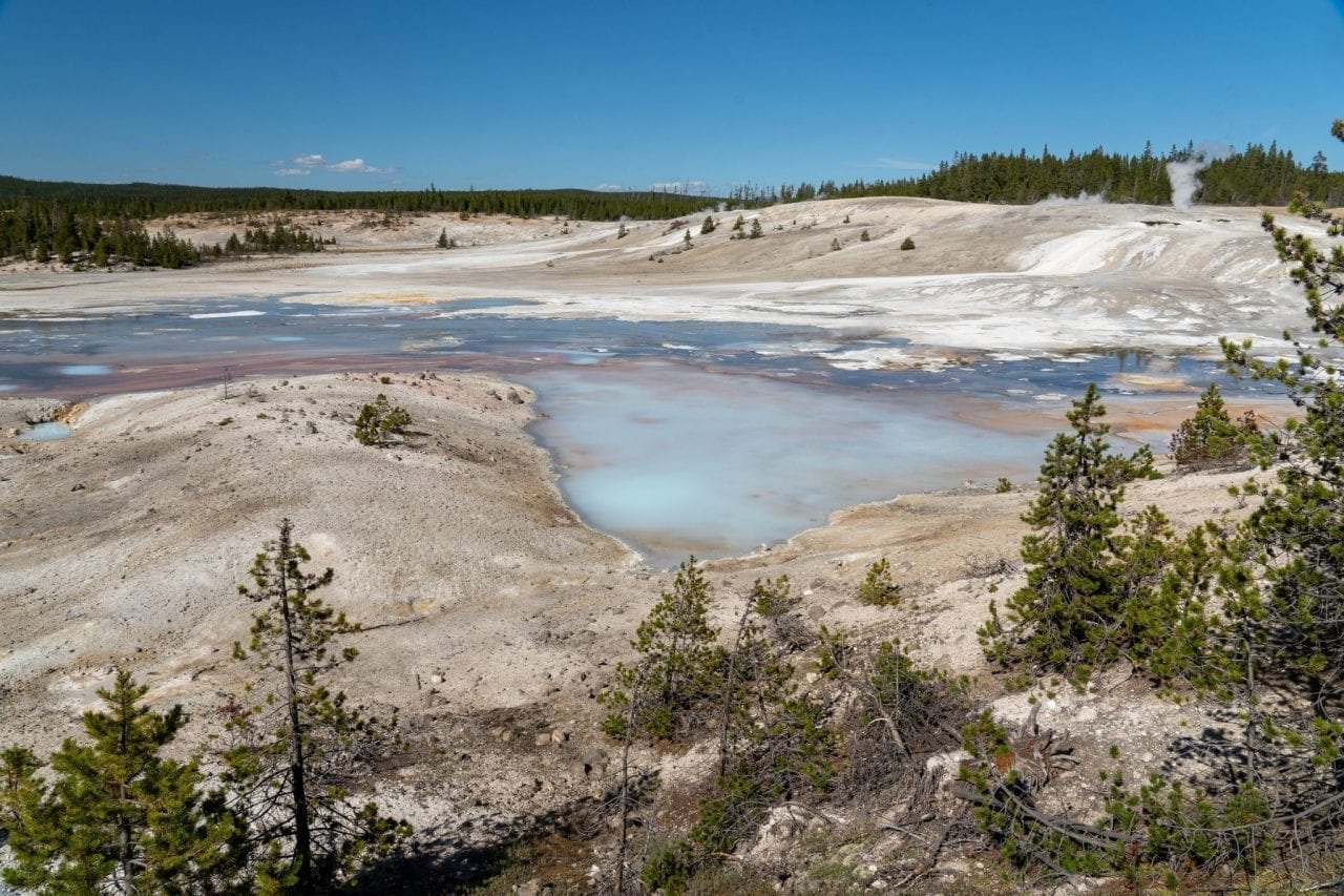 Turquoise blue waters of geyser in Norris Basin